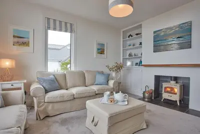 a living room with a couch and a fireplace at Tamarisk House in Newquay