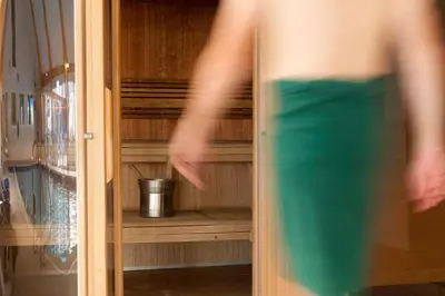 a person walking in front of a closet at Retallack Resort 4 bedroom lodge - Hot Tub for hire on request -Pool & Spa in Padstow