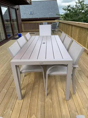 a white picnic table and chairs on a deck at Retallack Resort 4 bedroom lodge - Hot Tub for hire on request -Pool & Spa in Padstow