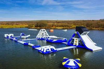 a group of water slides in the water at KingFisher Hot Tub & log Burner house on Premium lakeside with Resort Facilities in Saint Columb Major