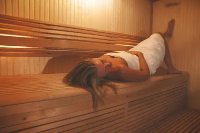 a woman laying on the back of a sauna at Skylark sleeps 8 private Hot Tub & Dogs welcome Nr Padstow, Resort Pool Bar & Watersports in Saint Columb Major