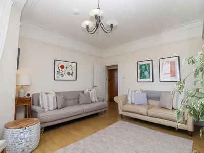 a living room with two couches and a table at Whistler in St Ives