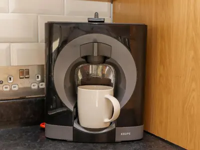 a coffee maker with a cup inside of it at Whistler in St Ives