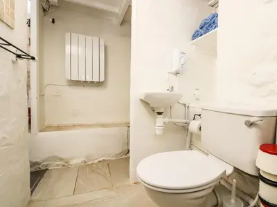 a bathroom with a toilet and a sink at The Old Stable in Helston