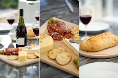 a table with wine and food and wine glasses at Sea La Vie in Carbis Bay