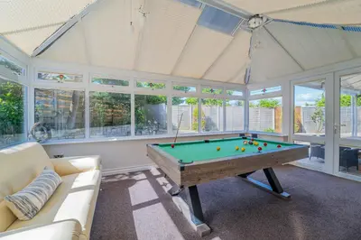 a living room with a pool table in it at Sea La Vie in Carbis Bay