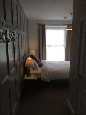 a bedroom with a bed and a window at Portreath Arms in Portreath