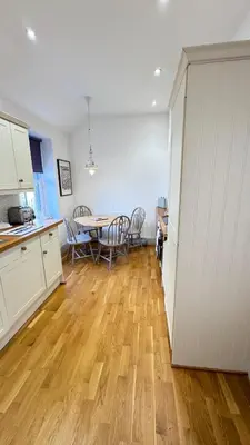 a kitchen and dining room with a table and chairs at Harbour Retreat Padstow - Entire Apartment in the beautiful old town of Padstow Harbour in Padstow