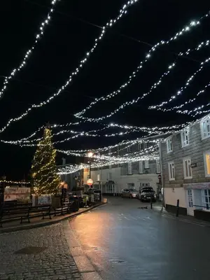 a street with christmas lights and a christmas tree at Harbour Retreat Padstow - Entire Apartment in the beautiful old town of Padstow Harbour in Padstow