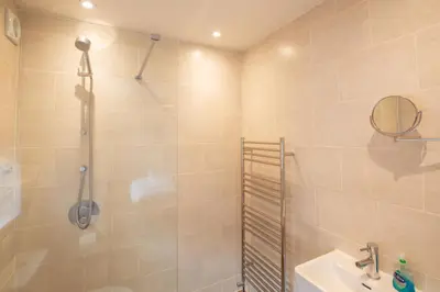 a bathroom with a shower and a sink at Gargoyle Cottage in St. Agnes