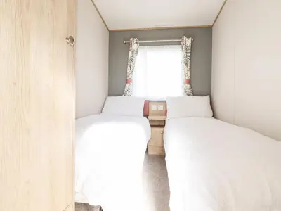 two beds in a small room with a window at 109 Bude in Newquay