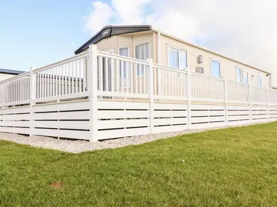 a house with a white fence in a yard at 109 Bude in Newquay
