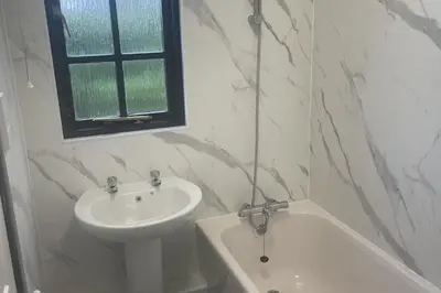 a bathroom with a sink and a toilet and a bath tub at Tudor Cottage Hayle - a Family & Dog Favourite in Hayle
