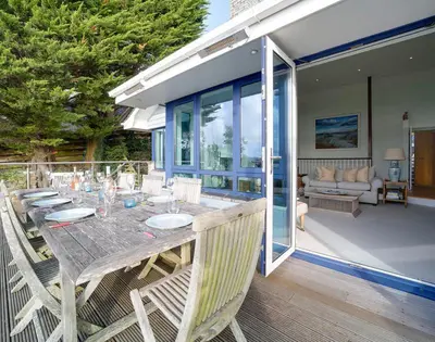 a wooden table and chairs on a patio at Camel Point in Wadebridge