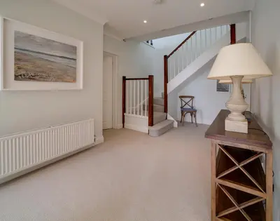 a living room with a lamp and a staircase at Camel Point in Wadebridge