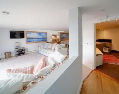 a living room with a couch and a tv at Camel Point in Wadebridge