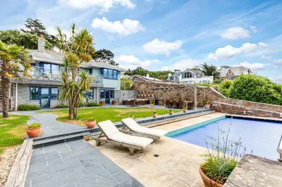 a home with a swimming pool and a house at Camel Point in Wadebridge