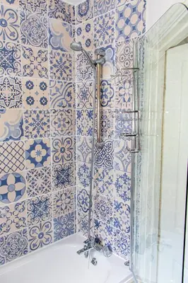 a bathroom with blue and white tiles on the wall at Clevedon House - Newquay - Beaches - Parking in Newquay