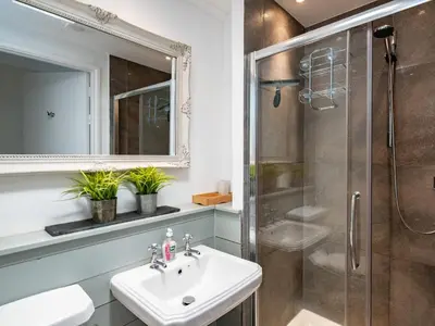 a bathroom with a sink and a shower at Croft Elms in Wadebridge