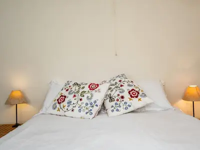 a white bed with two pillows on top of it at Croft Elms in Wadebridge