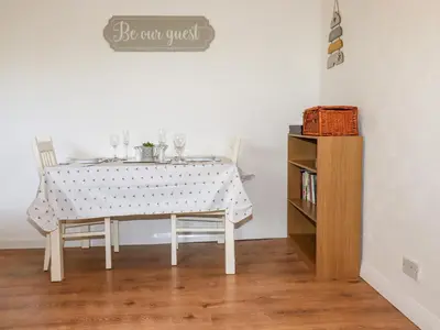 a dining room table with chairs and a sign that reads be cant trust at EdyVean in St Austell