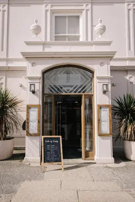 a white building with a sign in front of it at The Godolphin Hotel in Marazion
