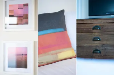 a room with a bed and a dresser and a picture at The Lighthouse in St Ives