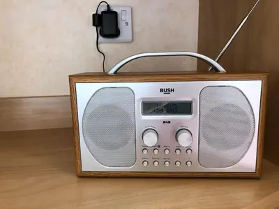an old radio sitting on top of a wooden floor at Bluebird K16 in St Merryn