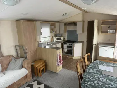 a small kitchen and living room in a caravan at Bluebird K16 in St Merryn