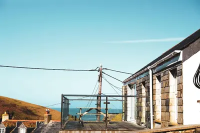 an old building with a view of the ocean at Stowaway, Port Isaac Bay Holidays in Port Isaac