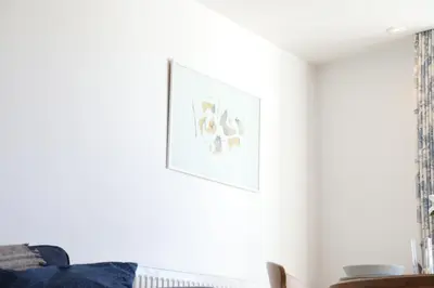 a living room with a picture on the wall at Stowaway, Port Isaac Bay Holidays in Port Isaac