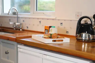 a plate of loaves of bread on a kitchen counter at Tamarisk, Port Isaac Bay Holidays in Port Isaac