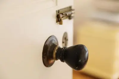 a black door knob on a white door at Tamarisk, Port Isaac Bay Holidays in Port Isaac