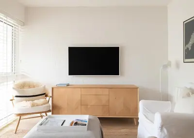 a living room with a tv on a wall at Westward 8 in Polzeath