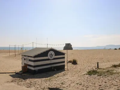 a black and white building on the beach at FurnessThe West Dry in St Austell