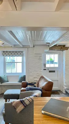 a living room with a couch and a table at Lobster Cove, Excellent location, Close to beach & coastal walks, Family run in Port Isaac