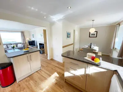 a kitchen with a large island in a room at Sunnybank, Port Isaac Bay Holidays in Port Isaac