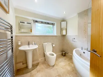 a bathroom with a toilet and a sink and a tub at Sunnybank, Port Isaac Bay Holidays in Port Isaac