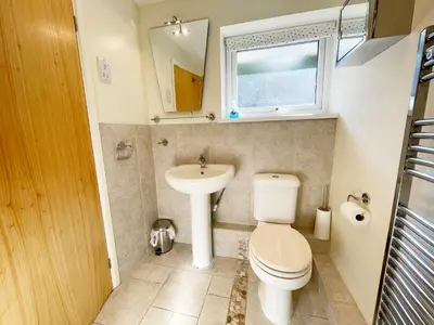 a small bathroom with a toilet and a sink at Sunnybank, Port Isaac Bay Holidays in Port Isaac