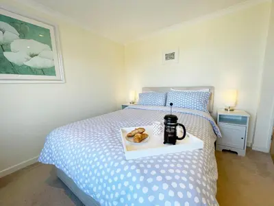 a bedroom with a bed with a tray of donuts on it at Sunnybank, Port Isaac Bay Holidays in Port Isaac