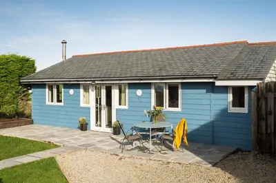 a blue house with a table in front of it at The Hut in Bodmin
