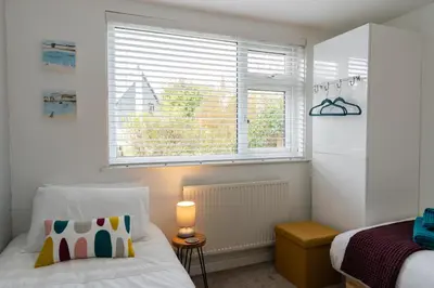 a bedroom with a bed and a window at Finest Retreats - Tinners Rest in St Austell
