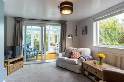 a living room with a couch and a tv at Finest Retreats - Tinners Rest in St Austell