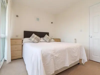 a bedroom with a white bed with two pillows at 24 Atlantic Reach in Newquay