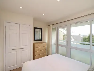 a bedroom with a bed and a large window at 24 Atlantic Reach in Newquay