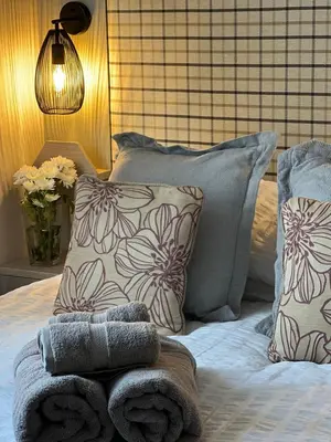 a bed with pillows and towels on top of it at Summer Breeze @ Seven Bays, Padstow in Padstow