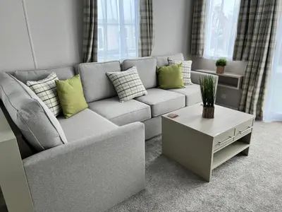 a living room with a couch and a coffee table at Summer Breeze @ Seven Bays, Padstow in Padstow