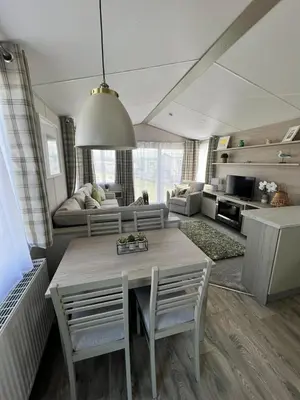 a living room with a table and chairs and a couch at Summer Breeze @ Seven Bays, Padstow in Padstow