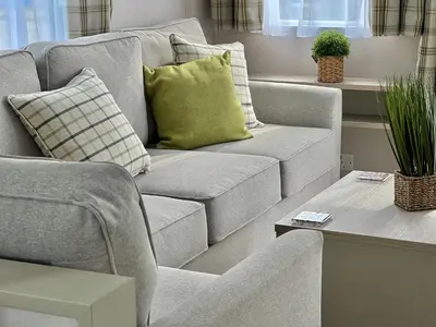 a living room with a couch and a table at Summer Breeze @ Seven Bays, Padstow in Padstow