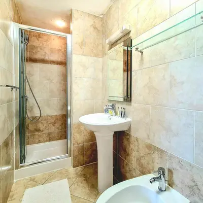 a bathroom with a sink and a shower at Ta Mill Holiday Cottages & Lodges -Ta Mill House in Launceston